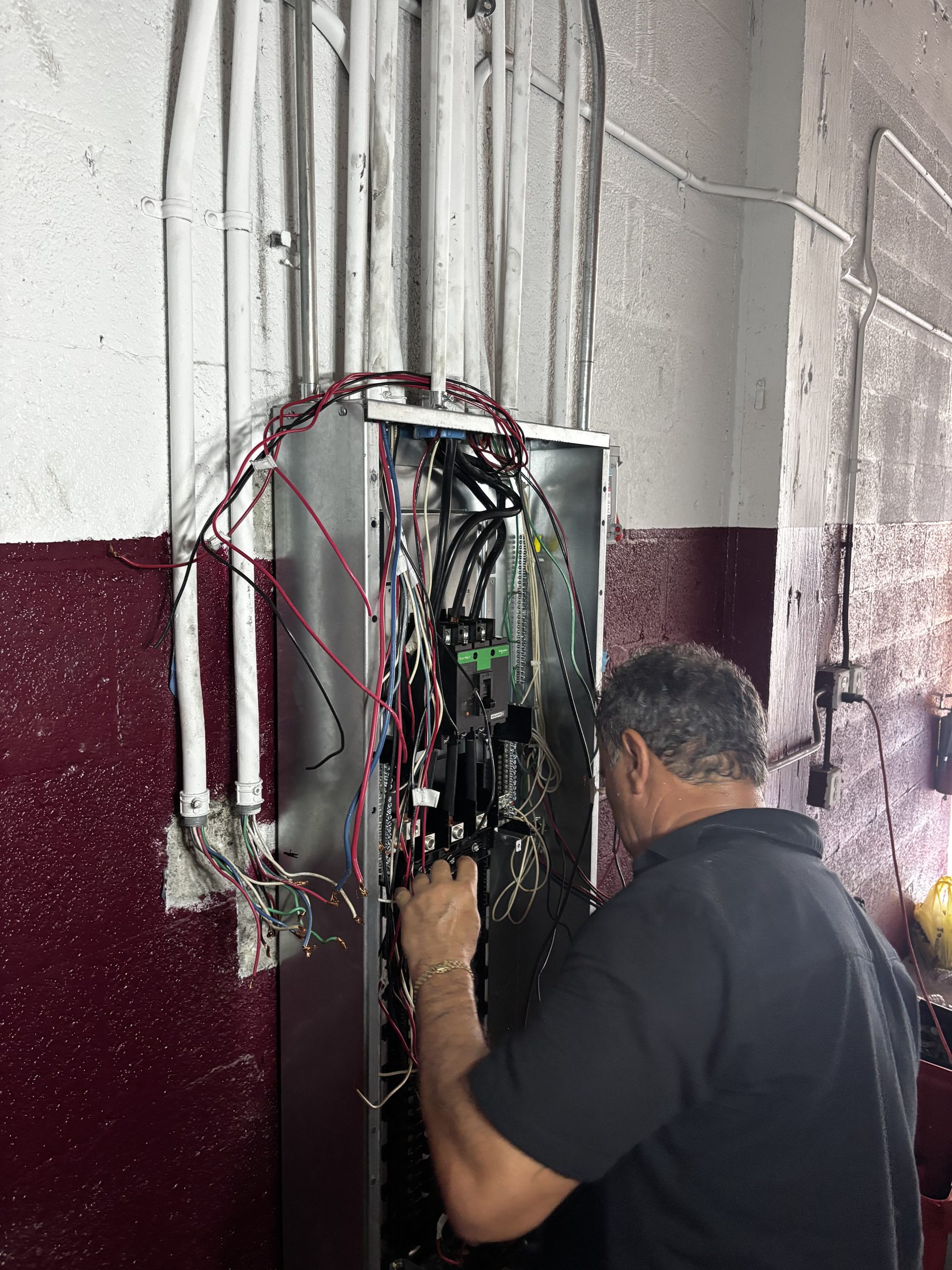Herrera Electric working on an industrial warehouse panel