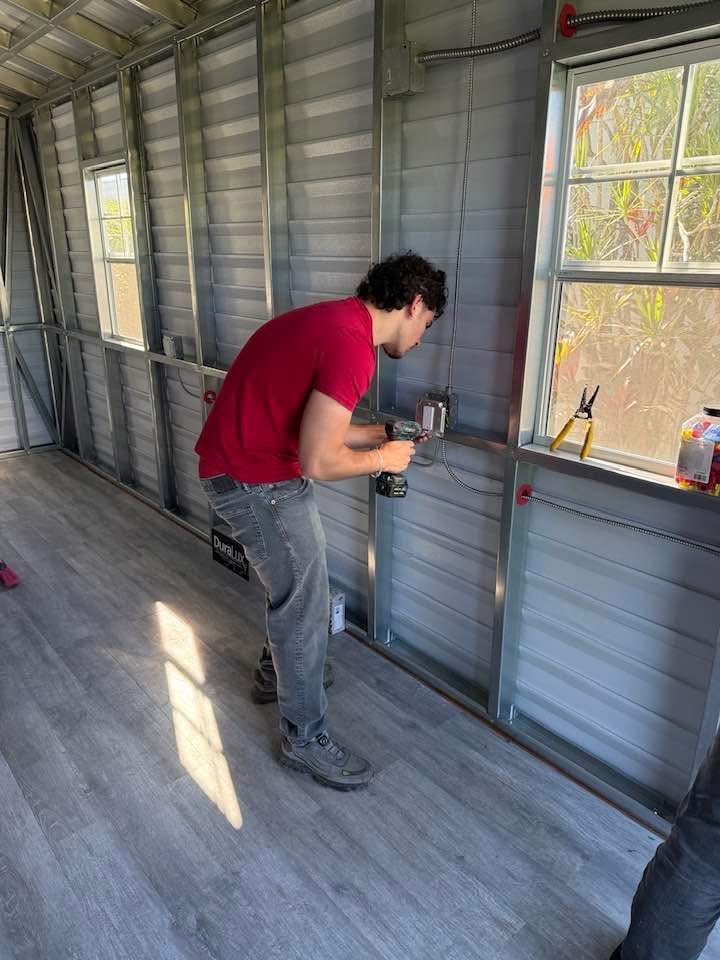 Herrera Electric employee installing an electrical outlet